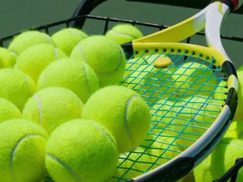 Tennis balls balanced on racket